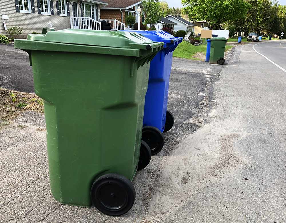 wheeled recycling containers at curb for collection