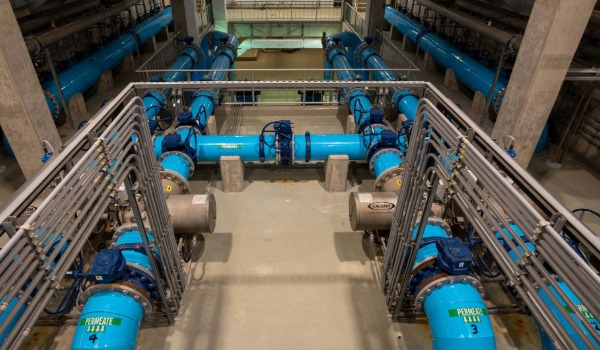 Large high-pressure pipes pumping drinking water through the community.